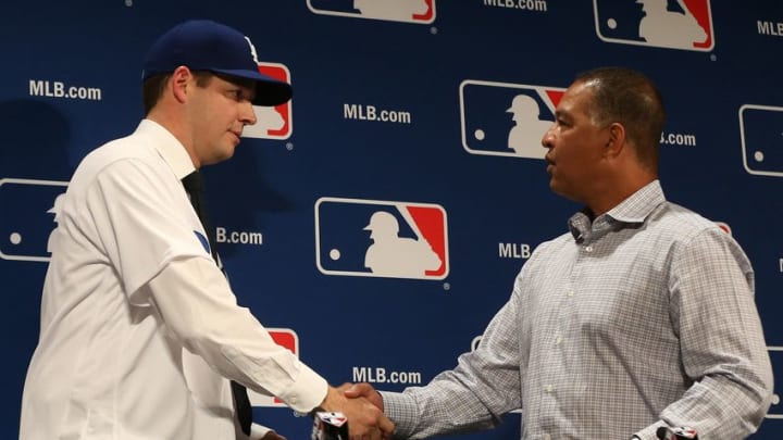 Dec 5, 2016; National Harbor, MD, USA; Los Angeles Dodgers pitcher Rich Hill (left) shakes hands with Dodgers manager Dave Rogers (right) at a press conference announcing Hill