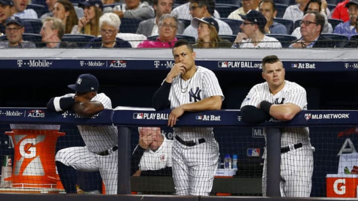 NEW YORK, NEW YORK - OCTOBER 09: Andrew McCutchen #26, Giancarlo Stanton #27 and Luke Voit #45 of the New York Yankees looks on from the dugout against the Boston Red Sox in Game Four of the American League Division Series at Yankee Stadium on October 09, 2018 in the Bronx borough of New York City. (Photo by Mike Stobe/Getty Images)