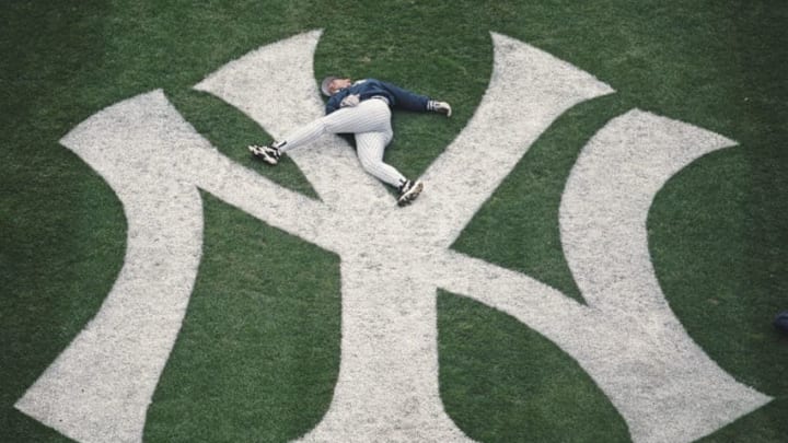 Pitcher David Cone of the New York Yankess goes through his warm up stretching routine on the teams infield logo before the season opening day Major League Baseball American League game against the Kansas City Royals on 9 April 1996 at Yankee Stadium, New York, New York, United States. The Yankees won the game 7 - 3. Visions of Sport. (Photo by Al Bello/Allsport/Getty Images) Pitcher David Cone of the New York Yankess goes through his warm up stretching routine on the teams infield logo before the season opening day Major League Baseball American League game against the Kansas City Royals on 9 April 1996 at Yankee Stadium, New York, New York, United States. The Yankees won the game 7 - 3. Visions of Sport. (Photo by Al Bello/Allsport/Getty Images)