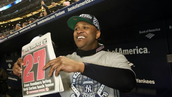 NEW YORK - NOVEMBER 04: C.C. Sabathia of the New York Yankees celebrates in the dugout with a copy of the New York Post after their 7-3 win against the Philadelphia Phillies in Game Six of the 2009 MLB World Series at Yankee Stadium on November 4, 2009 in the Bronx borough of New York City. (Photo by Nick Laham/Getty Images)
