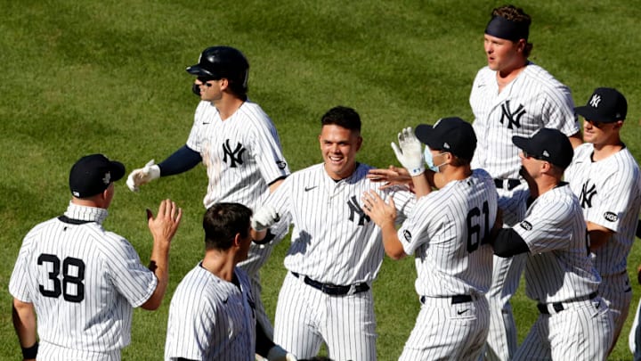 Gio Urshela #29 of the New York Yankees celebrates his eighth inning game winning base hit against the New York Mets during the first game of a doubleheader with his teammates at Yankee Stadium on August 30, 2020 in New York City. (Photo by Jim McIsaac/Getty Images)