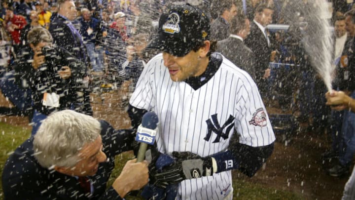 BRONX, NY - OCTOBER 16: Aaron Boone #19 of the New York Yankees is showered with champagne after hitting the game winning home run in the bottom of the eleventh inning against the Boston Red Sox during game 7 of the American League Championship Series on October 16, 2003 at Yankee Stadium in the Bronx, New York. The Yankees won 6-5, advancing them to the World Series. (Photo by Ezra Shaw/Getty Images)