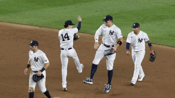 NEW YORK, NEW YORK - AUGUST 01: (NEW YORK DAILIES OUT) (L-R) Mike Tauchman #39, Tyler Wade #14, Aaron Judge #99 and Gleyber Torres #25 of the New York Yankees celebrate after defeating the Boston Red Sox at Yankee Stadium on August 01, 2020 in New York City. The Yankees defeated the Red Sox 5-2. (Photo by Jim McIsaac/Getty Images)