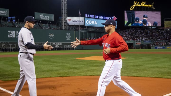 BOSTON, MA - OCTOBER 05: Manager Aaron Boone of the New York Yankees shakes hands with Manager Alex Cora of the Boston Red Sox as starting lineups are introduced during a pre-game ceremony before the 2021 American League Wild Card game at Fenway Park on October 5, 2021 in Boston, Massachusetts. (Photo by Billie Weiss/Boston Red Sox/Getty Images)