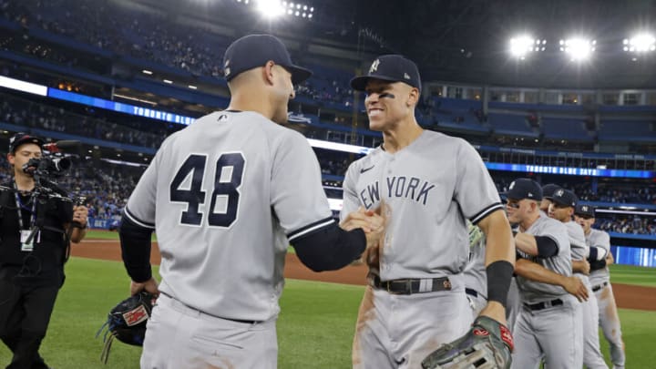 TORONTO, ON - SEPTEMBER 27: Aaron Judge #99 of the New York Yankees high-fives Anthony Rizzo #48 after defeating the Toronto Blue Jays to clinch first place in the American League East after the game at Rogers Centre on on September 27, 2022, in Toronto, Canada. (Photo by New York Yankees/Getty Images)
