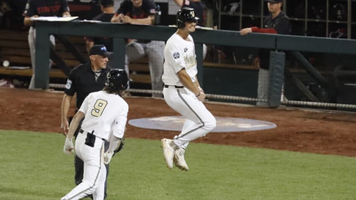 Jun 23, 2021; Omaha, Nebraska, USA; Vanderbilt Commodores utility player Spencer Jones (34) celebrates scoring the winning run with shortstop Carter Young (9) against the Stanford Cardinal at TD Ameritrade Park. Mandatory Credit: Bruce Thorson-USA TODAY Sports