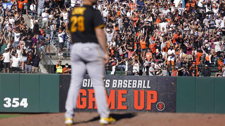 Fans cheer as Pittsburgh Pirates pitcher Wil Crowe, foreground, reacts after San Francisco Giants' Thairo Estrada hit a two-run home run during the ninth inning of a baseball game in San Francisco, Sunday, Aug. 14, 2022. (AP Photo/Jeff Chiu)