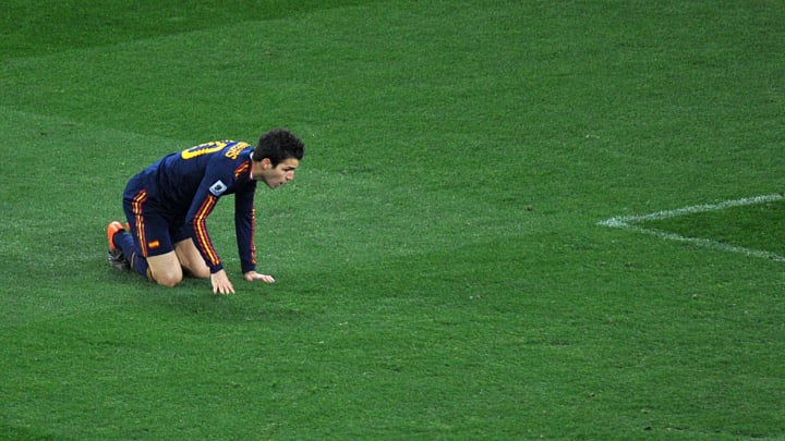 Spain's midfielder Cesc Fabregas gets up