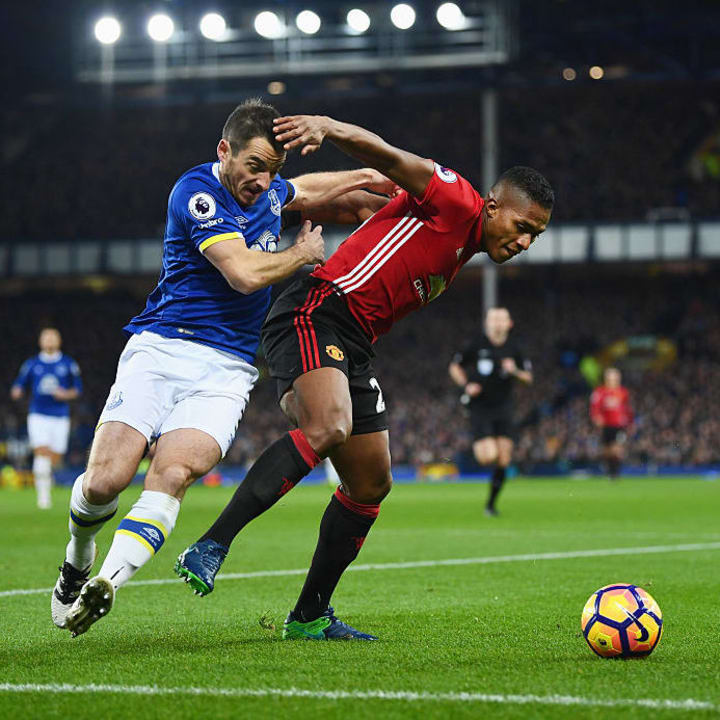 Valencia shields the ball from Leighton Baines