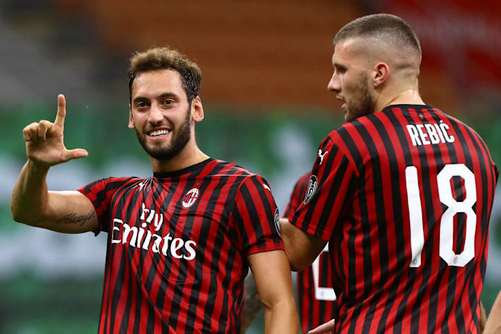 Hakan Calhanoglu (L) celebrates his opener against Atalanta, his fifth goal since Italian football returned in June