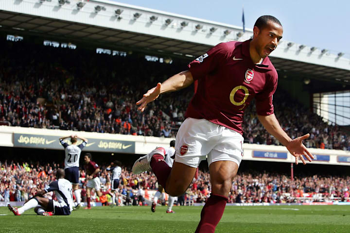 Arsenal's Thierry Henry (R) reacts after