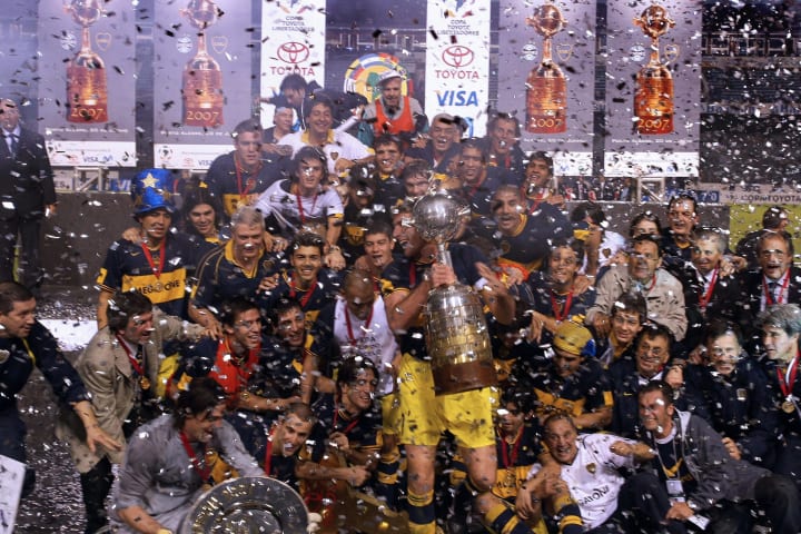 Boca Juniors footballers celebrate their...