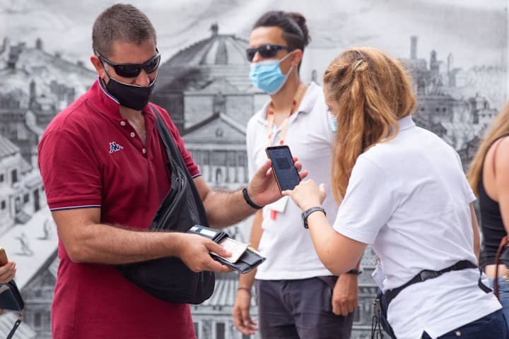 Operators check Green Pass for tourists queuing at the...