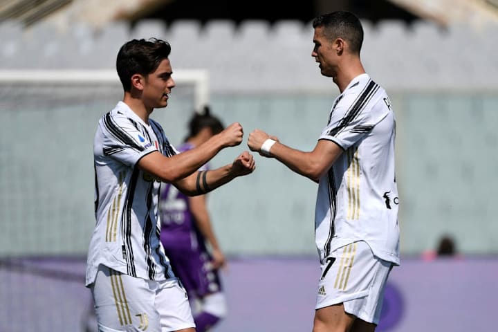 Paulo Dybala and Cristiano Ronaldo of Juventus FC encourage...
