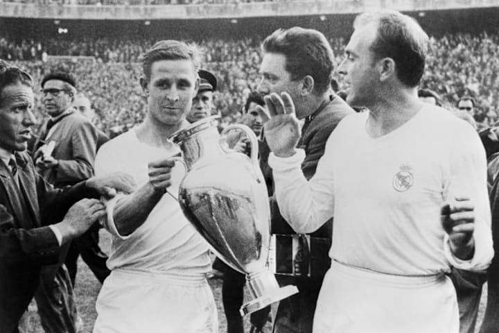 Raymond Kopa hoists aloft the European Cup alongside Alfredo Di Stéfano