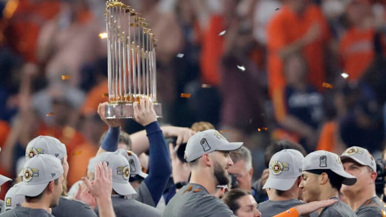 HOUSTON, TEXAS - NOVEMBER 05: The commissioner's trophy is lifted as the Houston Astros defeat the Philadelphia Phillies 4-1 to win the 2022 World Series in Game Six of the 2022 World Series at Minute Maid Park on November 05, 2022 in Houston, Texas. (Photo by Bob Levey/Getty Images)