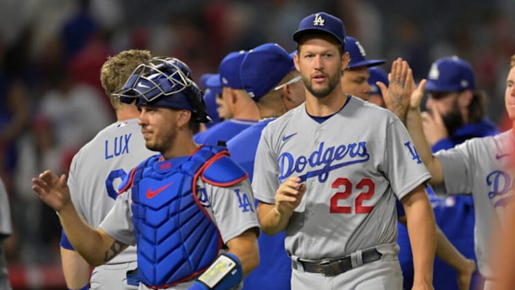 Jul 15, 2022; Anaheim, California, USA; Los Angeles Dodgers starting pitcher Clayton Kershaw (22) and catcher Austin Barnes (15) high five teammates following the ninth inning as they defeated the Los Angeles Angels at Angel Stadium. Mandatory Credit: Jayne Kamin-Oncea-USA TODAY Sports