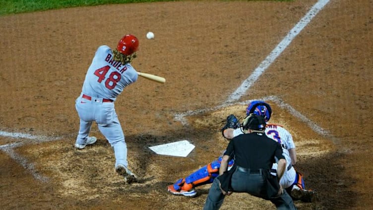 Sep 13, 2021; New York City, New York, USA; St. Louis Cardinals center fielder Harrison Bader (48) hits and RBI single against the New York Mets during the ninth inning at Citi Field. Mandatory Credit: Gregory Fisher-USA TODAY Sports