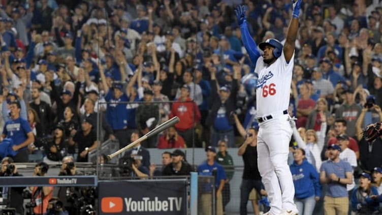 LOS ANGELES, CA - OCTOBER 27: Yasiel Puig #66 of the Los Angeles Dodgers tosses his bat aside and celebrates as his hit goes for a three-run home run to left field in the sixth inning of Game Four of the 2018 World Series against pitcher Eduardo Rodriguez #57 of the Boston Red Sox (not in photo) at Dodger Stadium on October 27, 2018 in Los Angeles, California. (Photo by Harry How/Getty Images)