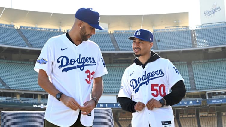 LOS ANGELES, CA - FEBRUARY 12: Los Angeles Dodgers Mookie Betts #50 and David Price #33 adjust their jerseys as they are introduced at a press conference at Dodger Stadium on February 12, 2020 in Los Angeles, California. (Photo by Jayne Kamin-Oncea/Getty Images)