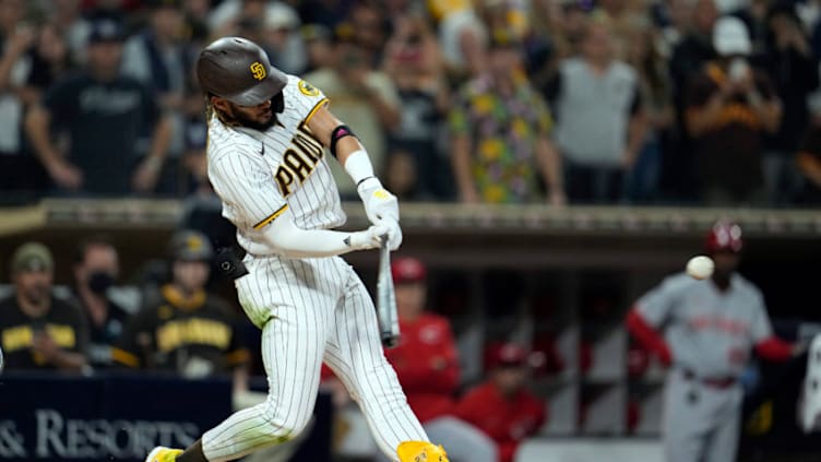 Jun 18, 2021; San Diego, California, USA; San Diego Padres shortstop Fernando Tatis Jr. (23) hits a single against the Cincinnati Reds in the fourth inning at Petco Park. Mandatory Credit: Ray Acevedo-USA TODAY Sports