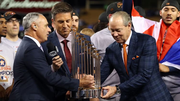 LOS ANGELES, CA - NOVEMBER 1: Major League Baseball Commissioner Robert D. Manfred Jr. presents the Commissioner's Trophy to the Houston Astros owner Jim Crane after the Astros defeated the Los Angeles Dodgers in Game 7 of the 2017 World Series at Dodger Stadium on Wednesday, November 1, 2017 in Los Angeles, California. (Photo by Alex Trautwig/MLB via Getty Images)