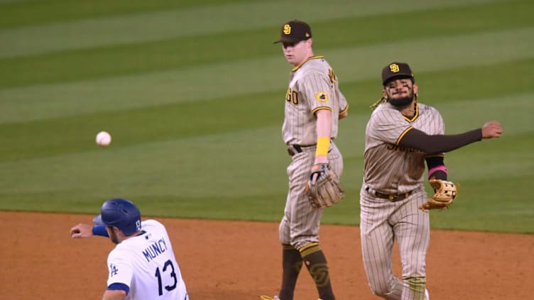 LOS ANGELES, CALIFORNIA - APRIL 24: Fernando Tatis Jr. #23 of the San Diego Padres throws for a double play in front of Jake Cronenworth #9 and Max Muncy #13 of the Los Angeles Dodgers during the seventh inning at Dodger Stadium on April 24, 2021 in Los Angeles, California. (Photo by Harry How/Getty Images)