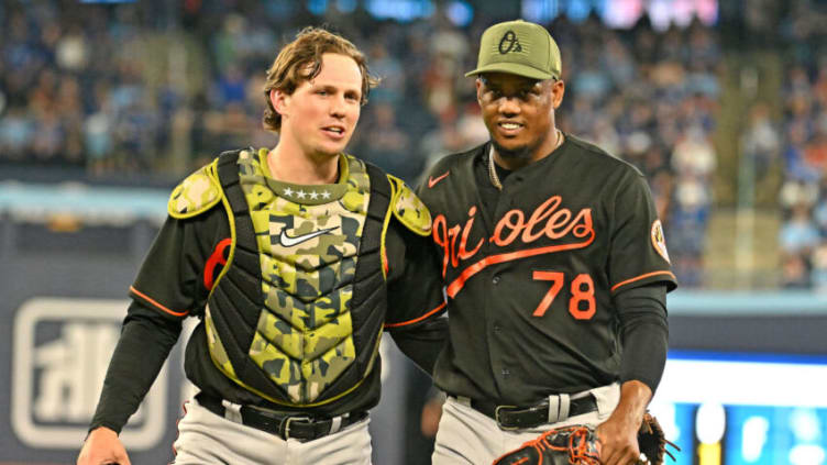 May 19, 2023; Toronto, Ontario, CAN; Baltimore Orioles catcher Adley Rutschman (35) and relief pitcher Yennier Cano (78) leave the field after the eighth inning against the Toronto Blue Jays at Rogers Centre. Mandatory Credit: Dan Hamilton-USA TODAY Sports