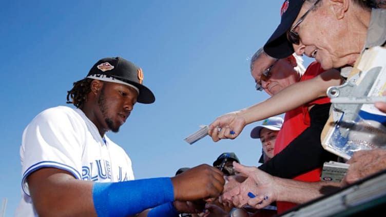 SURPRISE, AZ - OCTOBER 17: Vladimir Guerrrero Jr. #27 of the Surprise Saguaros and Toronto Blue Jays signs autographs during the 2018 Arizona Fall League on October 17, 2018 at Surprise Stadium in Surprise, Arizona. (Photo by Joe Robbins/Getty Images)