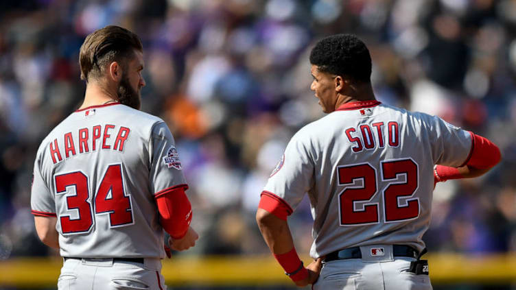 DENVER, CO - SEPTEMBER 30: Bryce Harper #34 and Juan Soto #22 of the Washington Nationals have a word after Harper was stranded on the bases after the top of the fourth inning of a game against the Colorado Rockies at Coors Field on September 30, 2018 in Denver, Colorado. (Photo by Dustin Bradford/Getty Images)