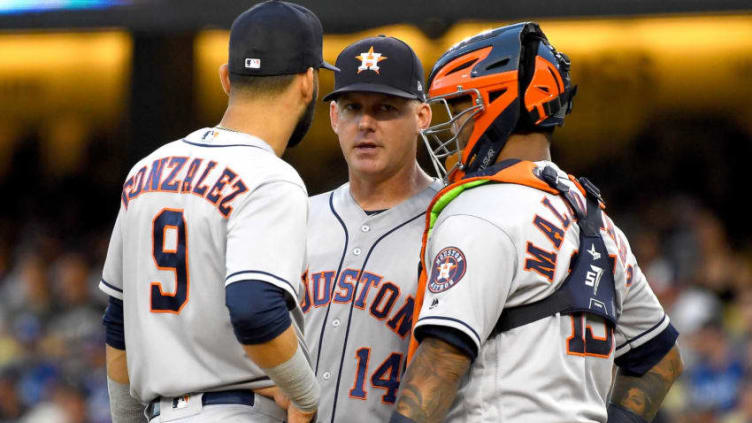 LOS ANGELES, CA - AUGUST 04: Manager AJ Hinch #14 stands on the mound with Marwin Gonzalez #9 and Martin Maldonado #15 of the Houston Astros as they wait for a new pitcher in the fifth inning against the Los Angeles Dodgers at Dodger Stadium on August 4, 2018 in Los Angeles, California. Starter Lance McCullers Jr. #43 of the Houston Astros left with an injury in the fifth inning. (Photo by Jayne Kamin-Oncea/Getty Images)