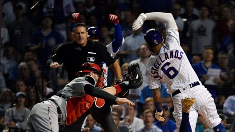 CHICAGO, ILLINOIS - SEPTEMBER 18: Nicholas Castellanos #6 of the Chicago Cubs beats the tag from Curt Casali #12 of the Cincinnati Reds to score in the fourth inning at Wrigley Field on September 18, 2019 in Chicago, Illinois. (Photo by Quinn Harris/Getty Images)