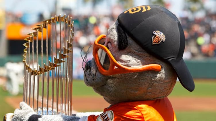 SAN FRANCISCO, CA - AUGUST 25: The San Francisco Giants mascot Lou Seal hugs the 2010 World Series trophy before the game against the Atlanta Braves at AT&T Park on August 25, 2012 in San Francisco, California. The Atlanta Braves defeated the San Francisco Giants 7-3. (Photo by Jason O. Watson/Getty Images)