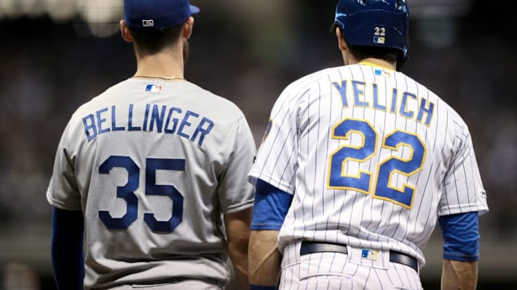 MILWAUKEE, WISCONSIN - APRIL 19: Cody Bellinger #35 of the Los Angeles Dodgers and Christian Yelich #22 of the Milwaukee Brewers stand at first base in the fifth inning at Miller Park on April 19, 2019 in Milwaukee, Wisconsin. (Photo by Dylan Buell/Getty Images)