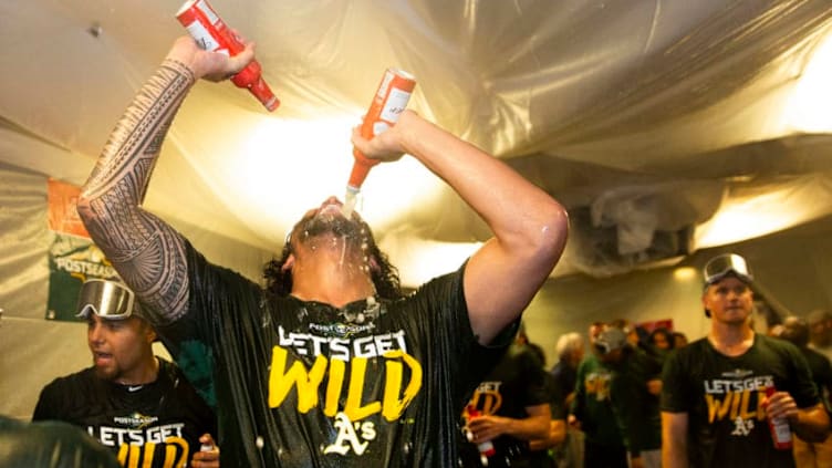 SEATTLE, WA - SEPTEMBER 27: Sean Manaea #55 of the Oakland Athletics pours beer into his mouth as he celebrates clinching a wild card spot after the game against the Seattle Mariners at T-Mobile Park on September 27, 2019 in Seattle, Washington. (Photo by Lindsey Wasson/Getty Images)