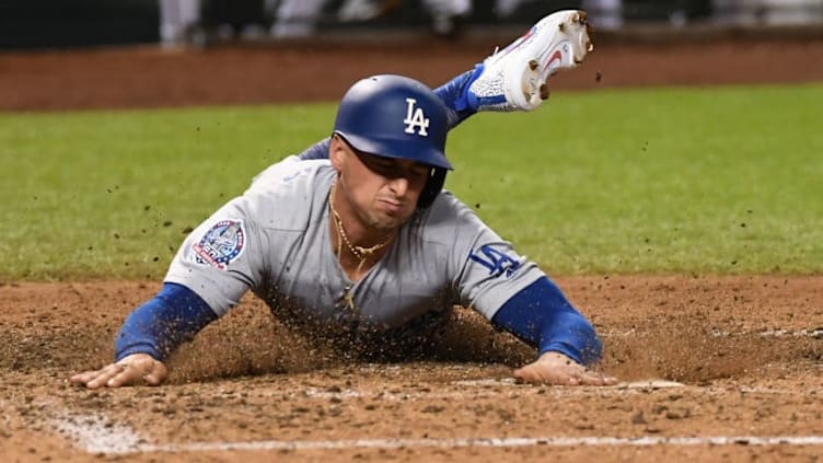 PHOENIX, AZ - SEPTEMBER 24: Tim Locastro #70 of the Los Angeles Dodgers scores on a single by teammate Max Muncy #13 during the seventh inning against the Arizona Diamondbacks at Chase Field on September 24, 2018 in Phoenix, Arizona. (Photo by Norm Hall/Getty Images)