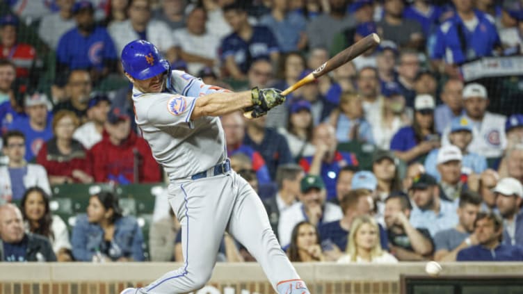 May 23, 2023; Chicago, Illinois, USA; New York Mets first baseman Pete Alonso (20) hits an RBI-single against the Chicago Cubs during the sixth inning at Wrigley Field. Mandatory Credit: Kamil Krzaczynski-USA TODAY Sports