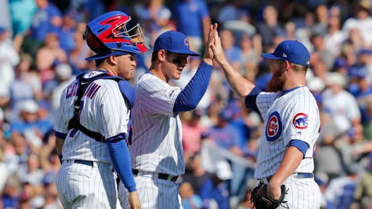 CHICAGO, ILLINOIS - AUGUST 03: Victor Caratini #7, Anthony Rizzo #44, and Craig Kimbrel #24 of the Chicago Cubs celebrate their team's 4-1 win over the Milwaukee Brewers at Wrigley Field on August 03, 2019 in Chicago, Illinois. (Photo by Nuccio DiNuzzo/Getty Images)