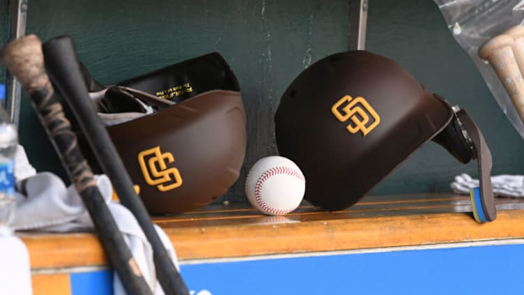 DETROIT, MI - JULY 25: A detailed view of two San Diego Padres batting helmets and a baseball sitting in the dugout during the game against the Detroit Tigers at Comerica Park on July 25, 2022 in Detroit, Michigan. The Tigers defeated the Padres 12-4. (Photo by Mark Cunningham/MLB Photos via Getty Images)