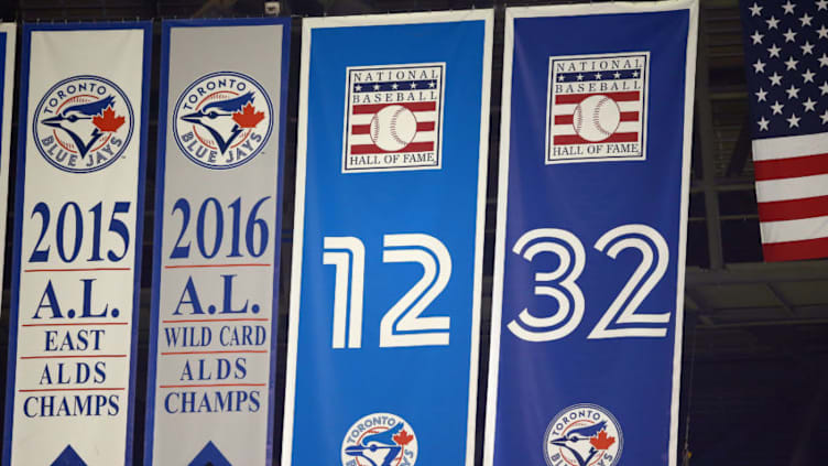 TORONTO, ON - JULY 22: A banner showing the retired number 32, belonging to former Toronto Blue Jays pitcher Roy Halladay, is updated with the National Baseball Hall of Fame logo, after Halladay was inducted into the Hall of Fame on July 21st, 2019, seen during a MLB game against the Cleveland Indians at Rogers Centre on July 22, 2019 in Toronto, Canada. (Photo by Vaughn Ridley/Getty Images)