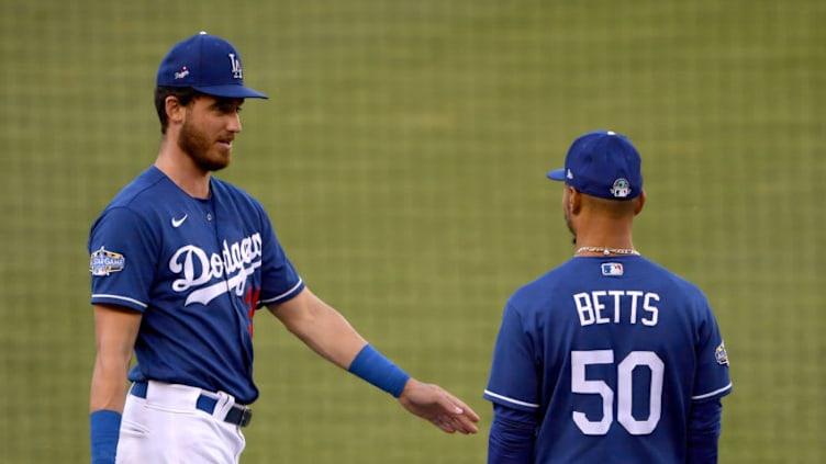 LOS ANGELES, CALIFORNIA - JULY 08: Cody Bellinger #35 of the Los Angeles Dodgers and Mookie Betts #50 talk during the Los Angeles Dodgers summer camp workout in preparation for the 2020 season amidst the coronavirus (COVID-19) pandemic at Dodger Stadium on July 08, 2020 in Los Angeles, California. (Photo by Harry How/Getty Images)