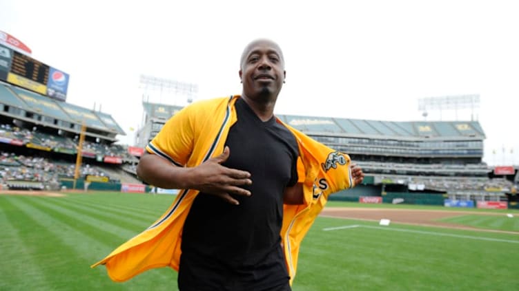 Recording artist M.C. Hammer puts on his jersey before throwing out the ceremonial first pitch before the start of the Oakland Athletics vs. Los Angeles Angels of Anaheim game on Sunday, July 17, 2011 at O.co Coliseum in Oakland, Calif. Today the Athletics gave out 15,000 M.C. Hammer bobbleheads. Hammer was a former A's batboy from 1973 to 1980. Oakland defeated Los Angeles 9-1. (Jose Carlos Fajardo/Staff) (Photo by MediaNews Group/Bay Area News via Getty Images)