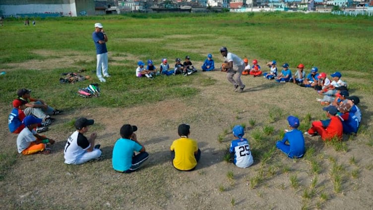 Cuban children attend a baseball class in a field of Havana, on September 17, 2018. - Football took over baseball in the preference of children and young people in Cuba, where the latter has been king for almost 150 years. (Photo by Yamil LAGE / AFP) (Photo credit should read YAMIL LAGE/AFP via Getty Images)