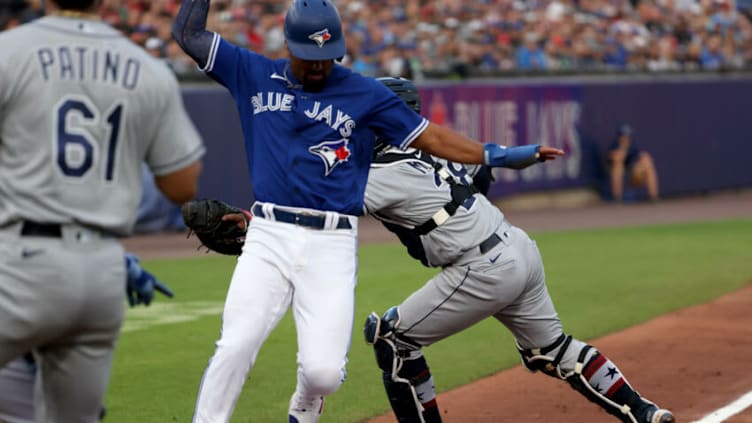 Jul 2, 2021; Buffalo, New York, USA; Tampa Bay Rays catcher Francisco Mejia (28) misses the tag as Toronto Blue Jays second baseman Marcus Semien (10) is safe at home plate during the second inning at Sahlen Field. Mandatory Credit: Timothy T. Ludwig-USA TODAY Sports