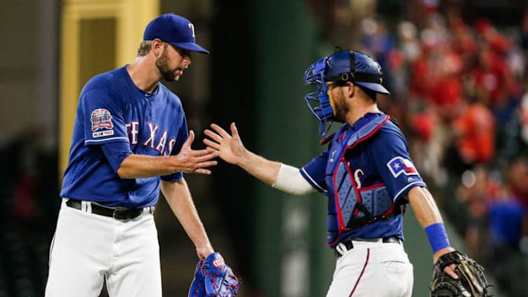 ARLINGTON, TX - JULY 11: Relief pitcher Chris Martin #31, left, of the Texas Rangers and Jeff Mathis #2 celebrate a 5-0 win over the Houston Astros after a baseball game at Globe Life Park July 11, 2019 in Arlington, Texas. (Photo by Brandon Wade/Getty Images)