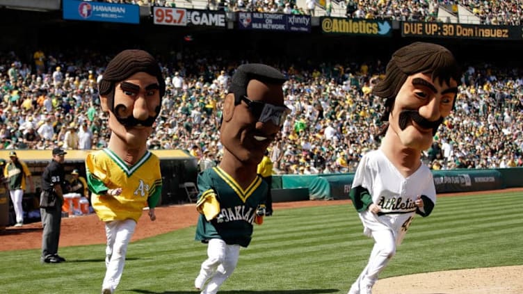 OAKLAND, CA - APRIL 19: Oakland Athletics mascots of former players (L-R) Rollie Fingers, Rickey Henderson, and Dennis Eckersley running on field in race at O.co Coliseum on April 19, 2014 in Oakland, California. (Photo by Ezra Shaw/Getty Images)