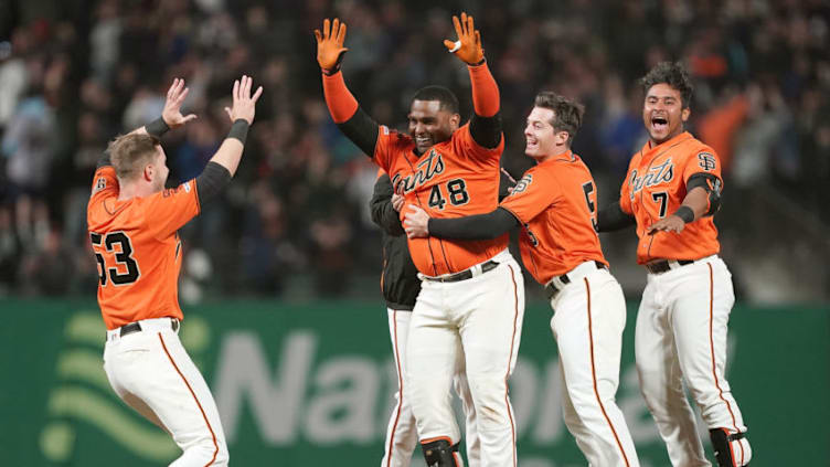 SAN FRANCISCO, CA - JULY 19: Pablo Sandoval #48 of the San Francisco Giants and teammates celebrates after Sandoval hit a fly ball to left field that was dropped for an error by Dominic Smith #22 of the New York Mets allowing the Giants to win the game 1-0 in 10 inning at Oracle Park on July 19, 2019 in San Francisco, California. (Photo by Thearon W. Henderson/Getty Images)