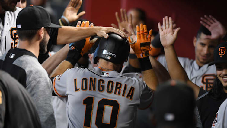 PHOENIX, AZ - AUGUST 05: Evan Longoria #10 of the San Francisco Giants celebrates with teammates in the dugout after hitting a solo home run off of Archie Bradley #25 of the Arizona Diamondbacks during the eighth inning at Chase Field on August 5, 2018 in Phoenix, Arizona. (Photo by Norm Hall/Getty Images)