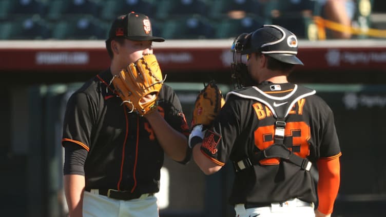 SCOTTSDALE, ARIZONA - MARCH 28: Kai-Wei Teng #82 and Patrick Bailey #93 of the SF Giants have a conversation after getting into a jam in the ninth inning against the Oakland Athletics in an MLB spring training game at Scottsdale Stadium. (Photo by Abbie Parr/Getty Images)