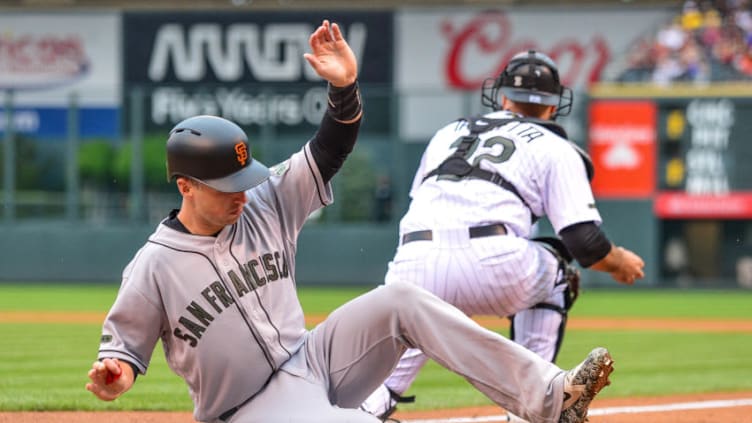 DENVER, CO - MAY 28: Buster Posey #28 of the San Francisco Giants slides across home plate for a first inning run against the Colorado Rockies at Coors Field on May 28, 2018 in Denver, Colorado. (Photo by Dustin Bradford/Getty Images)